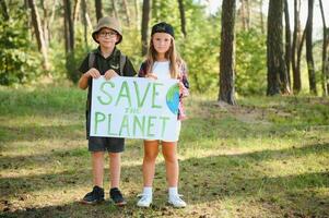 Children are holding a poster. Save the planet. photo
