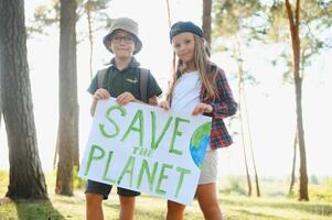 Children are holding a poster Save the planet. Earth Day. Let's save the planet from pollution. photo
