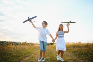 Active running kids with boy holding airplane toy. photo
