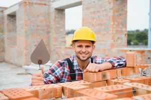 Construction worker in uniform and safety equipment have job on building photo