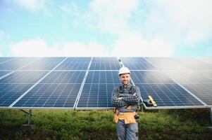 Professional worker installing solar panels on the metal construction, using different equipment, wearing helmet. Innovative solution for energy solving. Use renewable resources. Green energy. photo