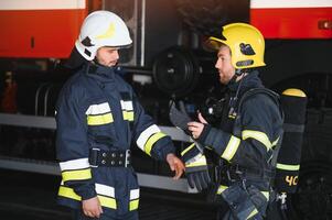 firemen leaving the station equipped and with the tools for the extinction of the fire photo