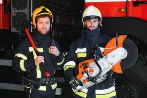 firemen leaving the station equipped and with the tools for the extinction of the fire photo