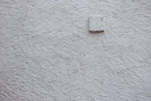 Wall fragment with scratches and cracks. Concrete cement wall texture with three dimensional elements. Modern design. Retro grunge style. Copy space. Wallpaper, banner, textures, background photo