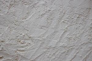 Wall fragment with scratches and cracks. Concrete cement wall texture with three dimensional elements. Modern design. Retro grunge style. Copy space. Wallpaper, banner, textures, background photo