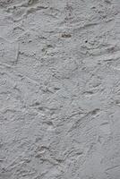 Wall fragment with scratches and cracks. Concrete cement wall texture with three dimensional elements. Modern design. Retro grunge style. Copy space. Wallpaper, banner, textures, background photo