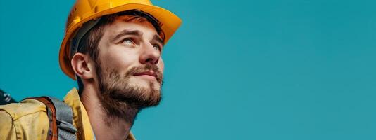 Hardworking Construction Worker in Protective Gear Focused on Building Project on Vibrant Blue Background photo