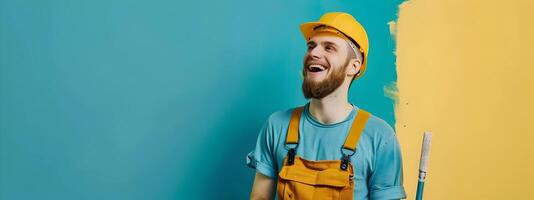Confident Construction Worker in Yellow Hardhat Painting Blue Wall photo