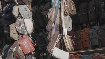 Turkey, Istanbul - June 2, 2022. Lots of bags at bazaar. Action. Large selection of bags on traditional open market. Bags for sale in Turkish market video