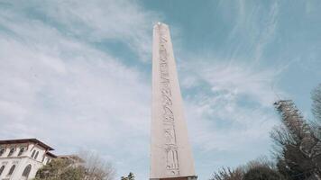 Turkey, Istanbul - June 2, 2022. Bottom view of ancient obelisk. Action. Long pillar of monument with ancient inscriptions. Ancient Egyptian obelisk of Theodosius in Istanbul video