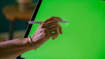 close-up photo of a persons hand, delicately gripping a modern stylus as it glides across a high-resolution graphic tablet