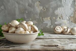 White Button Mushrooms in a Gray Bowl on a Wooden Table photo