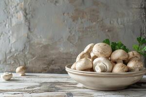 White Button Mushrooms in a Gray Bowl on a Wooden Table photo