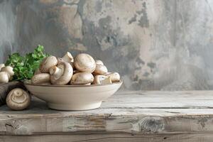 White Button Mushrooms in a Gray Bowl on a Wooden Table photo