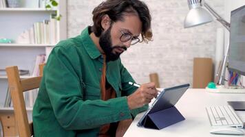 Graphic designer working with computer digital tablet stylus pen smartphone at modern office. video