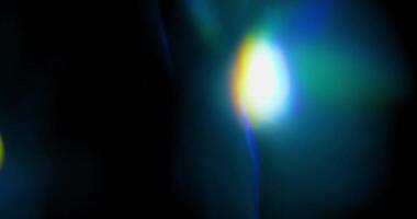 Lens flare, abstract bokeh lights moving. Leaking reflection of crystal on black background. video
