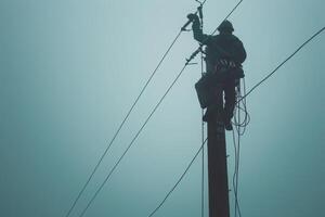 Electrician Working on a Power Pole photo