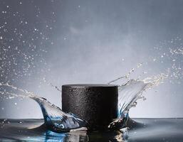 empty black podium mockup with water splash on a grey gradient background for product display photo