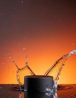 empty black podium mockup with water splash on a orange gradient background for product display photo