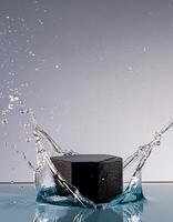 empty black podium mockup with water splash on a grey gradient background for product display photo