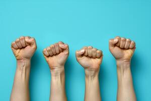 Fists Raised In Unity Against Black Background photo