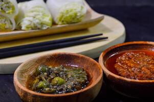Sawi gulung tahu or rolled Chinese cabbage with tofu. Served with red chilli sauce and green chilli sauce. photo