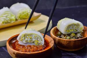 Sawi gulung tahu or rolled Chinese cabbage with tofu. Served with red chilli sauce and green chilli sauce. photo