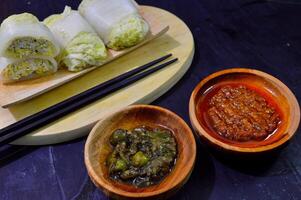 Sawi gulung tahu or rolled Chinese cabbage with tofu. Served with red chilli sauce and green chilli sauce. photo