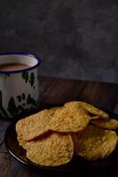 Tempeh chips are a food made from tempeh which is thinly sliced and then fried using seasoned flour. Usually the taste is salty with a savory onion aroma. photo