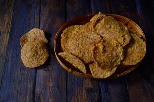 Tempeh chips are a food made from tempeh which is thinly sliced and then fried using seasoned flour. Usually the taste is salty with a savory onion aroma. photo