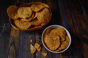 Tempeh chips are a food made from tempeh which is thinly sliced and then fried using seasoned flour. Usually the taste is salty with a savory onion aroma. photo