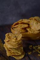 Tempeh chips are a food made from tempeh which is thinly sliced and then fried using seasoned flour. Usually the taste is salty with a savory onion aroma. photo