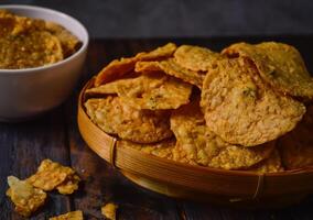 Tempeh chips are a food made from tempeh which is thinly sliced and then fried using seasoned flour. Usually the taste is salty with a savory onion aroma. photo