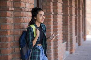 Female Institute Student Smiling While Holding Phone photo