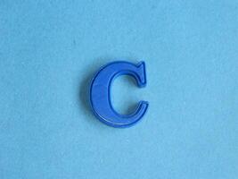 Macro photo or closeup photo of the alphabet from children's toys on a blue background. Use on preschool also