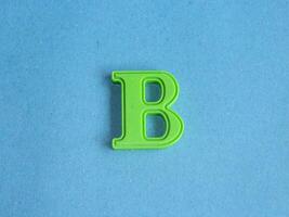 Macro photo or closeup photo of the alphabet from children's toys on a blue background. Use on preschool also