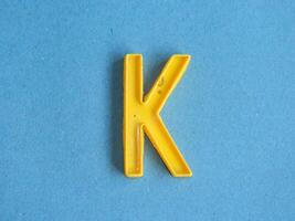 Macro photo or closeup photo of the alphabet from children's toys on a blue background. Use on preschool also