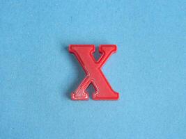 Macro photo or closeup photo of the alphabet from children's toys on a blue background. Use on preschool also