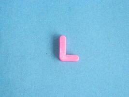 Macro photo or closeup photo of the alphabet from children's toys on a blue background. Use on preschool also