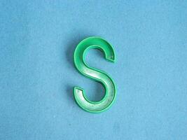 Macro photo or closeup photo of the alphabet from children's toys on a blue background. Use on preschool also