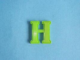 Macro photo or closeup photo of the alphabet from children's toys on a blue background. Use on preschool also