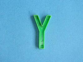 Macro photo or closeup photo of the alphabet from children's toys on a blue background. Use on preschool also
