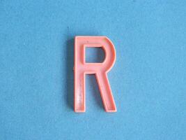 Macro photo or closeup photo of the alphabet from children's toys on a blue background. Use on preschool also