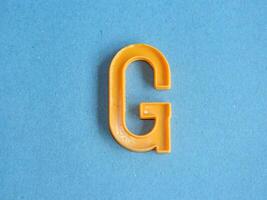 Macro photo or closeup photo of the alphabet from children's toys on a blue background. Use on preschool also