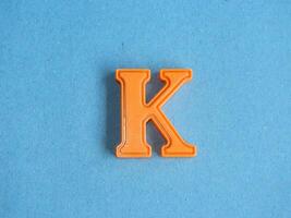 Macro photo or closeup photo of the alphabet from children's toys on a blue background. Use on preschool also