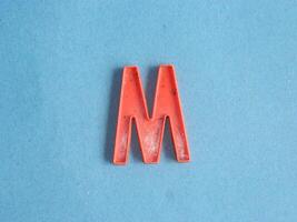 Macro photo or closeup photo of the alphabet from children's toys on a blue background. Use on preschool also