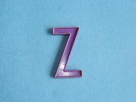 Macro photo or closeup photo of the alphabet from children's toys on a blue background. Use on preschool also
