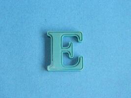 Macro photo or closeup photo of the alphabet from children's toys on a blue background. Use on preschool also