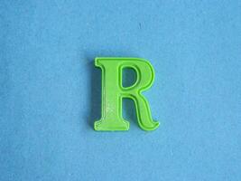 Macro photo or closeup photo of the alphabet from children's toys on a blue background. Use on preschool also