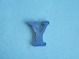 Macro photo or closeup photo of the alphabet from children's toys on a blue background. Use on preschool also